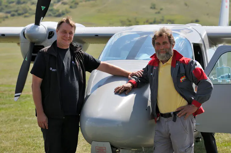 Wolfgang Neubauer und Sirri Seren (ZAMG) in front of a TECNAM MMA, an efficient multi-fuel twin engine aircraft developed, certified and marketed by Airborne Technologies. The employed sensors are of the newest technology and range from laser scanner systems to imaging spectroscopy and thermal measuring systems. Credit: Geert Verhoeven/LBI ArchPro.